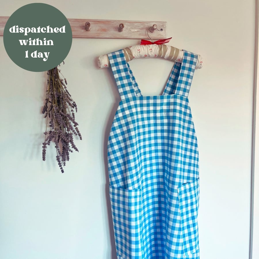 Cross back apron in blue cotton gingham