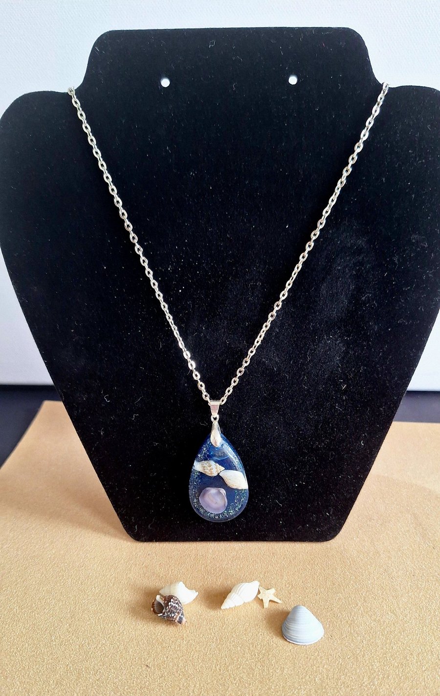 Blue shells in resin pendant