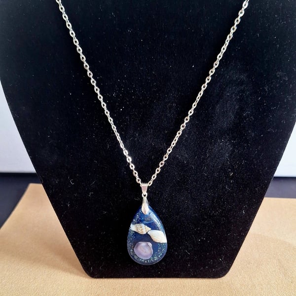 Blue shells in resin pendant