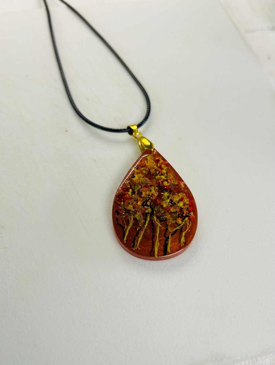 A hand painted and resin layered pendant necklace by Andrew Jenkins 
