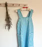 Cross back apron in blue cotton gingham