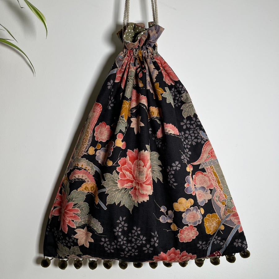 Japanese kimono fabric drawstring bag with pompoms and spotty cotton lining