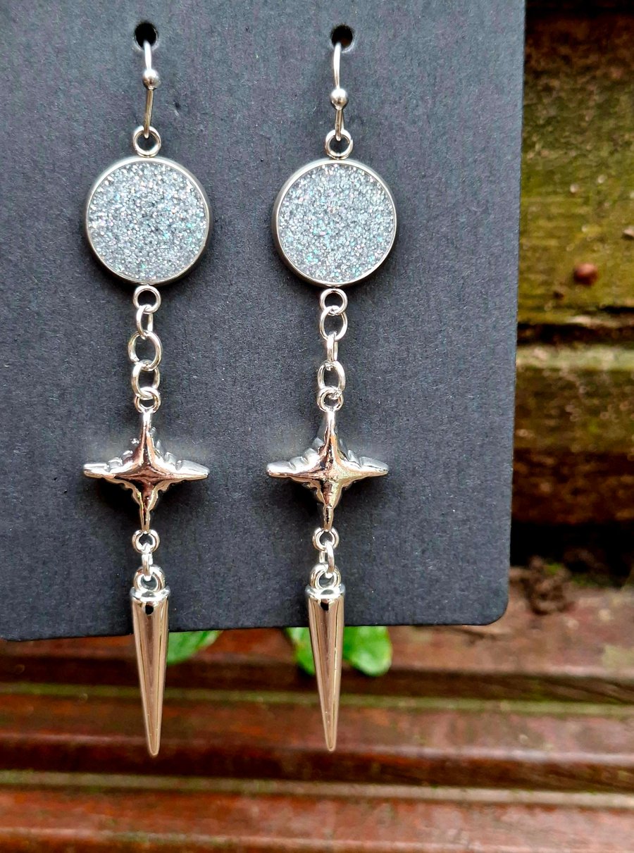 Gothic alternative silver shimmer star spike dangly earrings