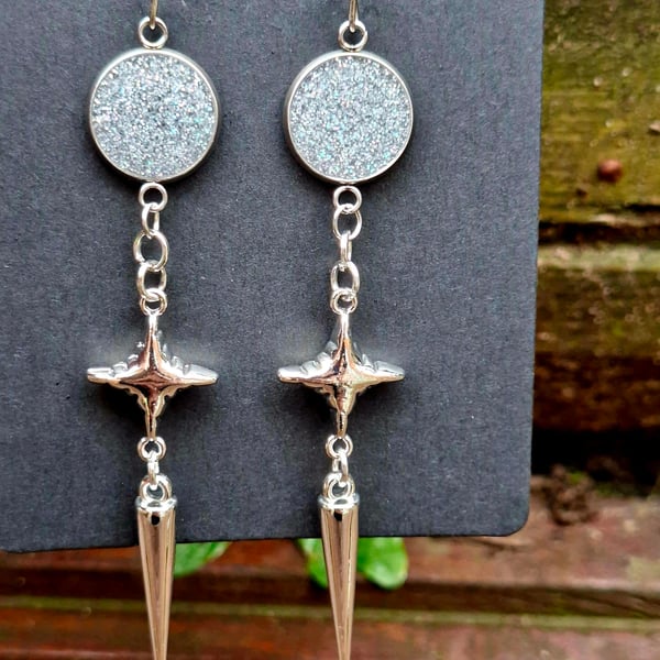 Gothic alternative silver shimmer star spike dangly earrings