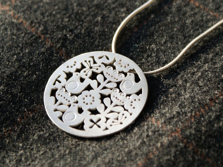 Silver flower and bird statement pendant