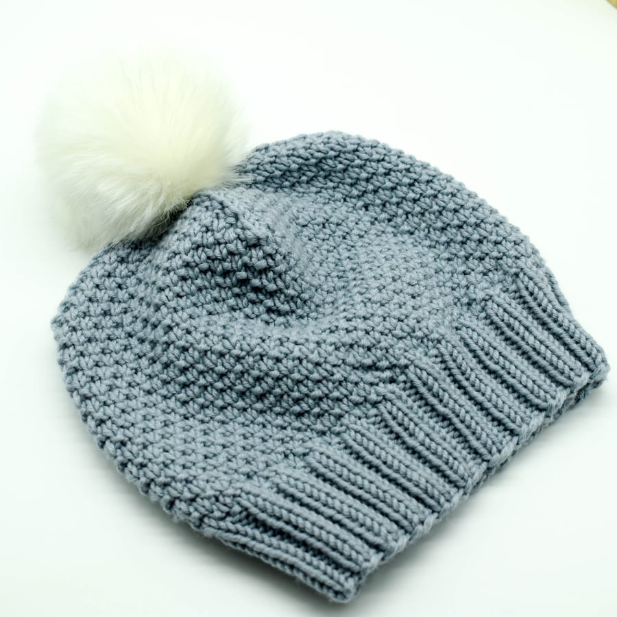 SOLD - Hand knitted toddler hat in dusky blue with faux fur pompom