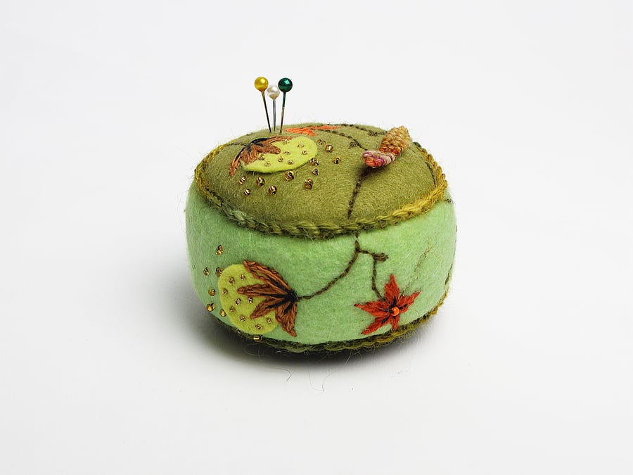 Green felt drum-shaped pin cushion with catkin embroidery