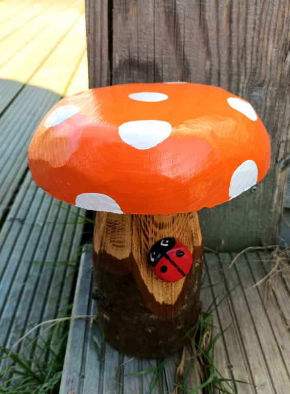 Orange toadstool with ladybird