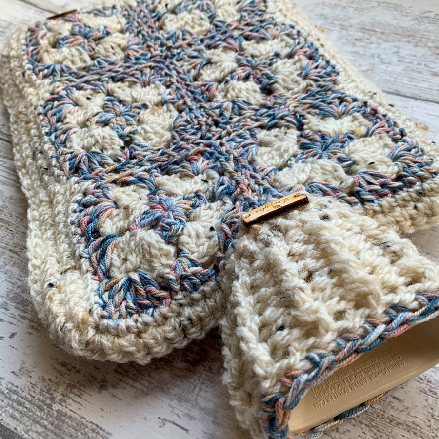 A hot water bottle and handmade crochet cover in tweed and blue