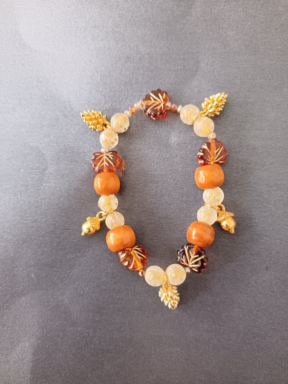 Elasticated Autumnal beaded bracelet with gold acorn and pine cone charms 