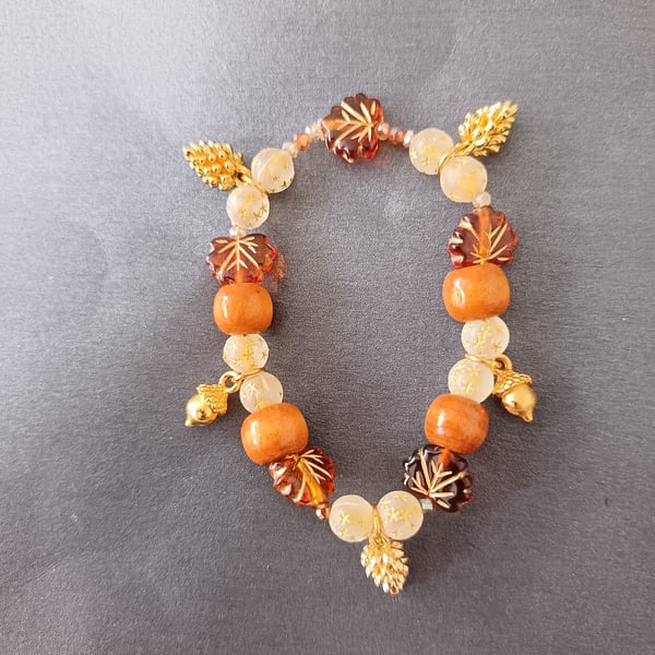 Elasticated Autumnal beaded bracelet with gold acorn and pine cone charms 
