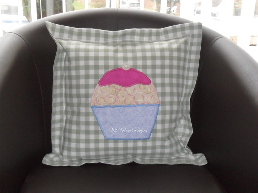   Cushion with appliquéd cupcake. 