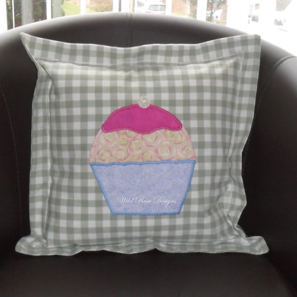   Cushion with appliquéd cupcake. 