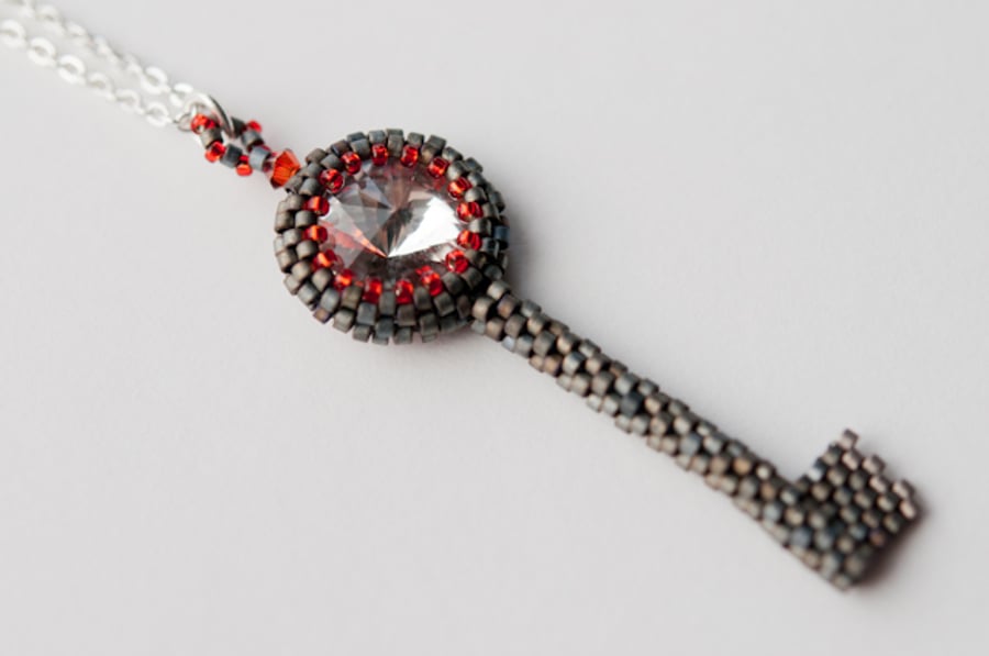 Pewter and red key shaped beadwoven pendant