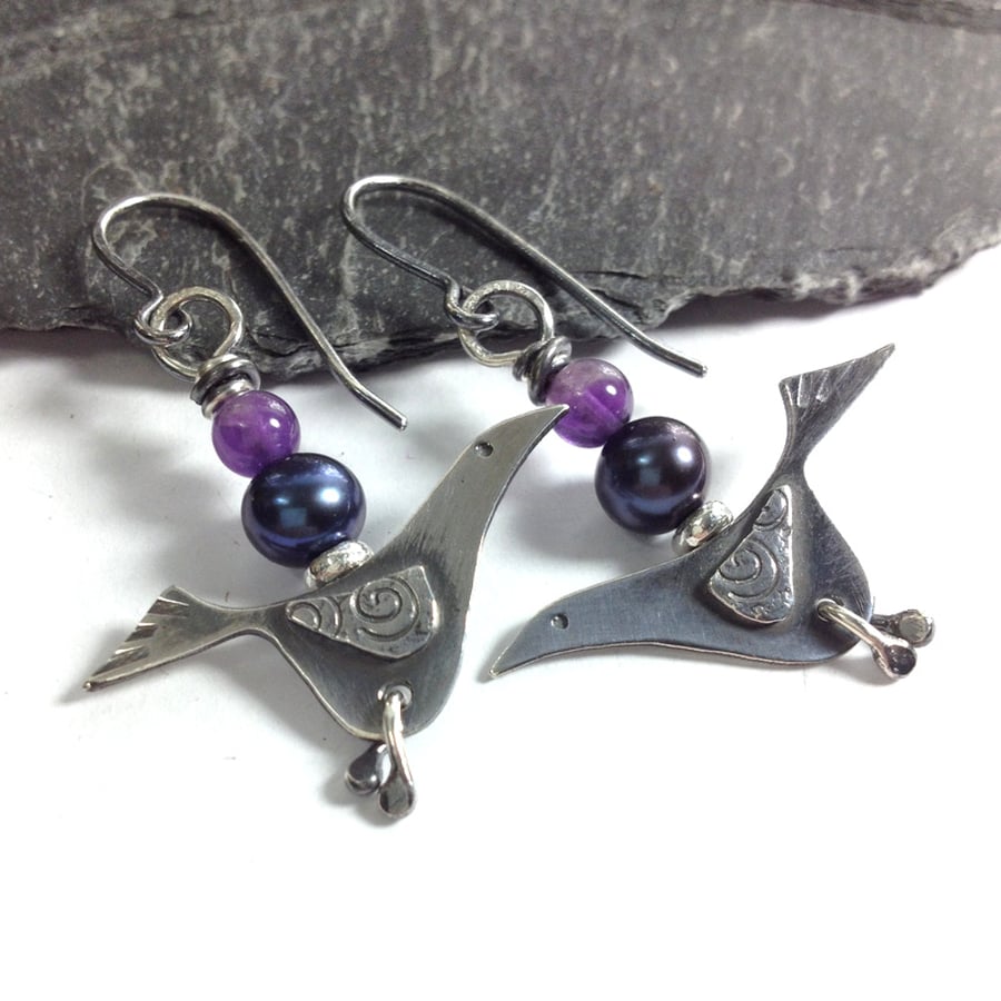 Silver bird earrings with amethyst and black pearl.