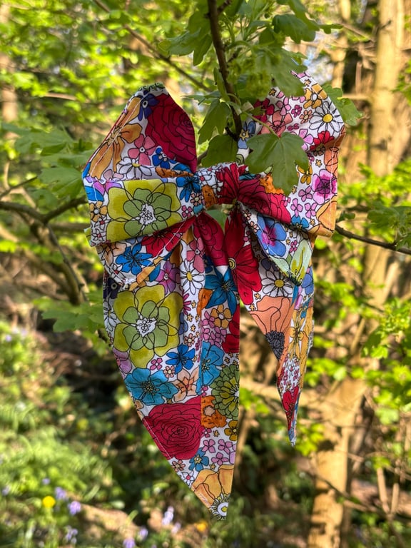 Hair bow on band in bright floral print