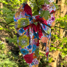 Hair bow on band in bright floral print