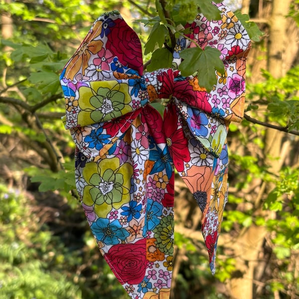 Hair bow on band in bright floral print