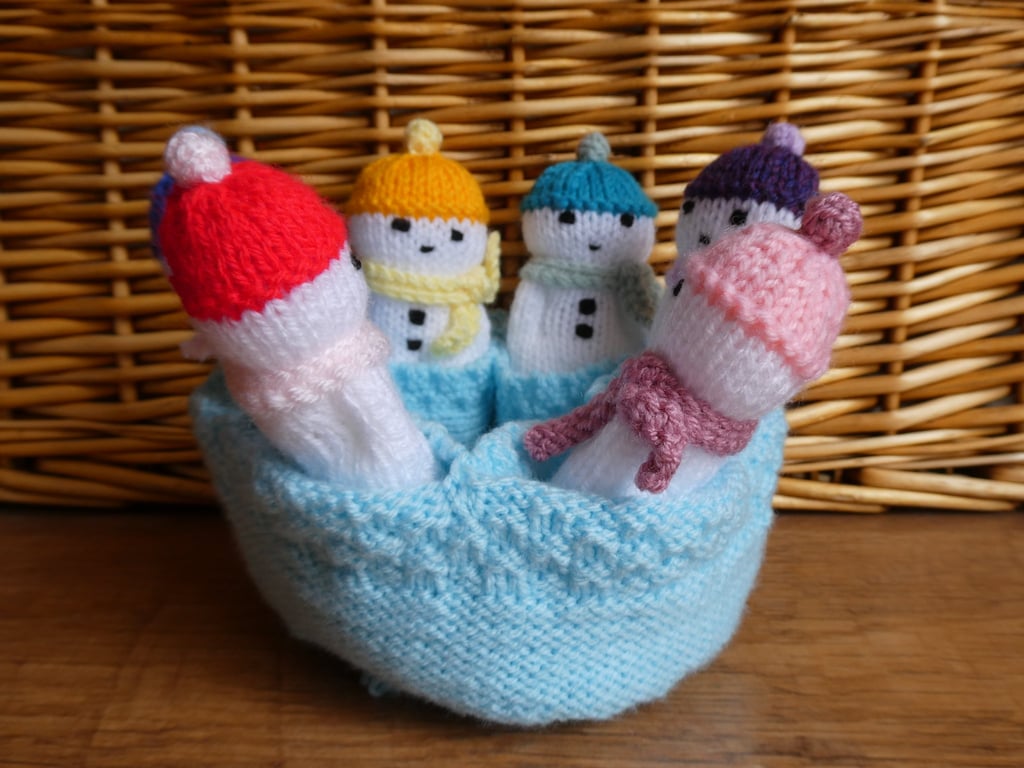 Handmade knitted snowmen in drawstring bag