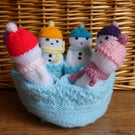 Handmade knitted snowmen in drawstring bag
