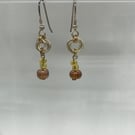 Rose link with pink, gold coloured beaded drop earrings.