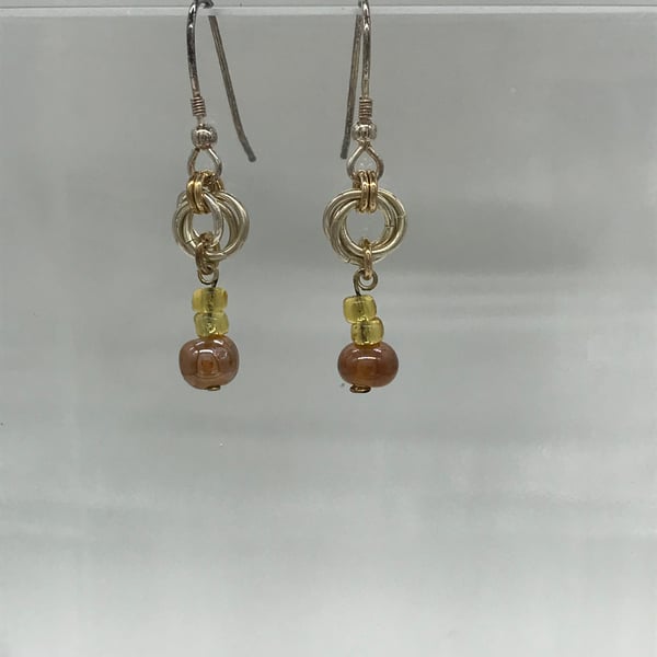 Rose link with pink, gold coloured beaded drop earrings.