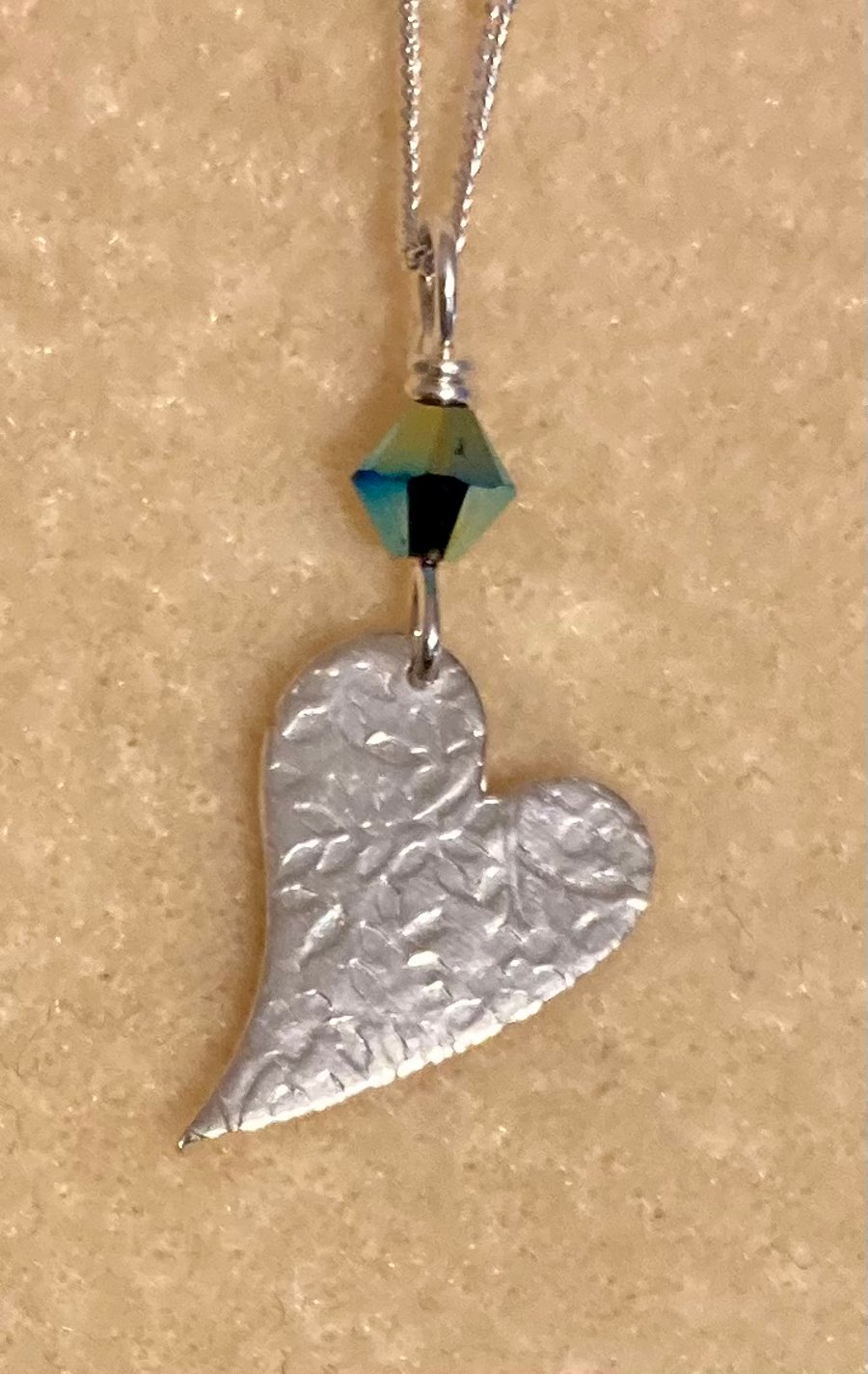 Pretty silver, angled heart with Swarovski crystal. 