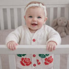 White cardigan, with standout English Rose motif. Soft and comfortable, fun gift