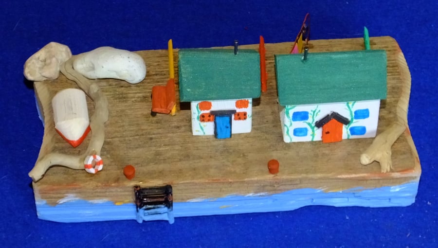 Harbourside scene with cottages rowing boat steps down wall to the sea