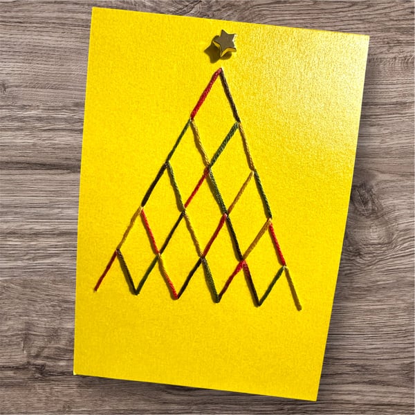 Hand embroidered Christmas card of a tree with star. Bright and colourful