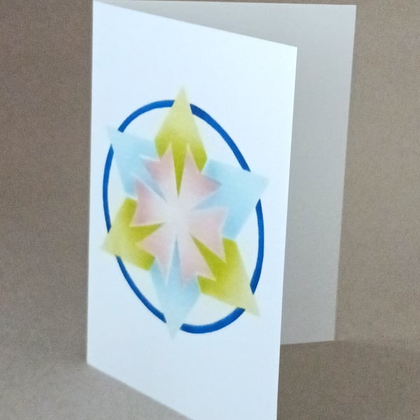 Star Mandala card, a blue and yellow green 6 pointed star on a blank inside card