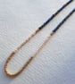 Glass beaded necklace, iridescent blue, gold, cream, 16 to 18 inches