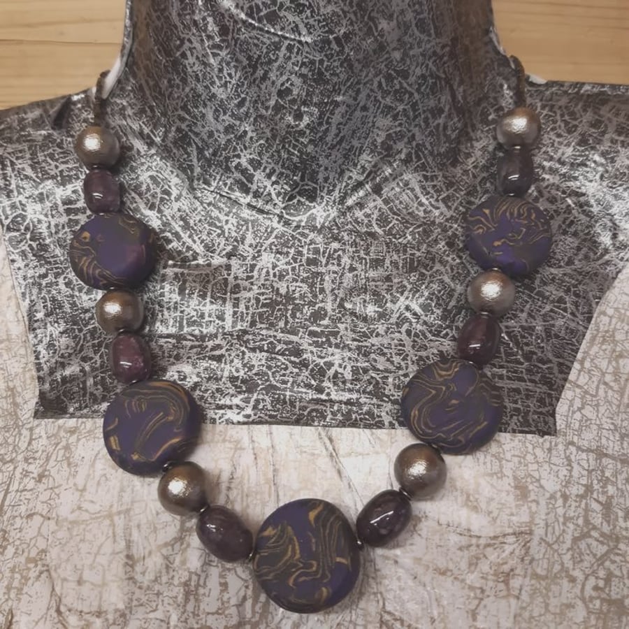 Purple, gold and black polymer clay disc shaped necklace 