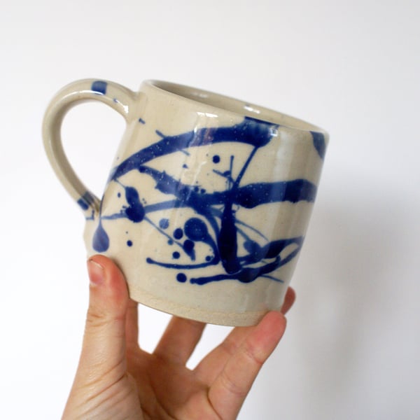 Straight sided white stoneware hand thrown pottery mug with ink blue splash