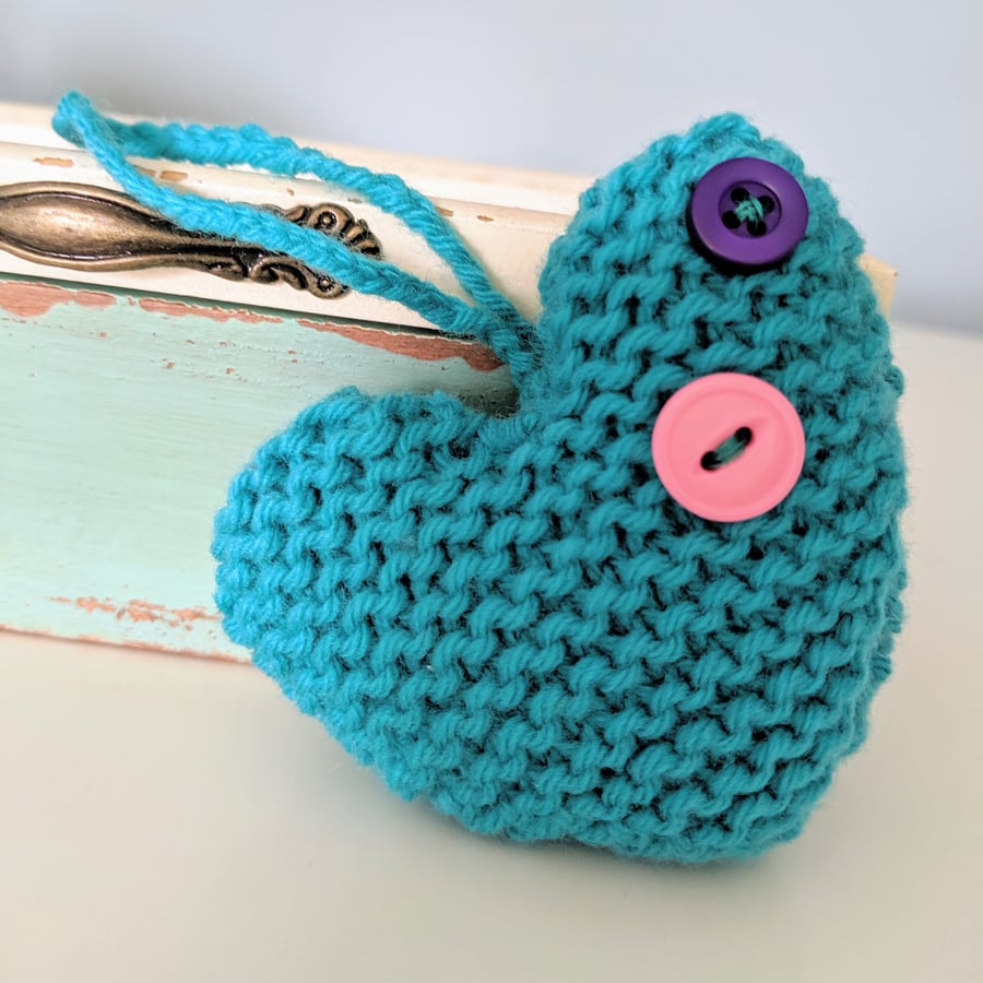 Hand-knitted teal button heart