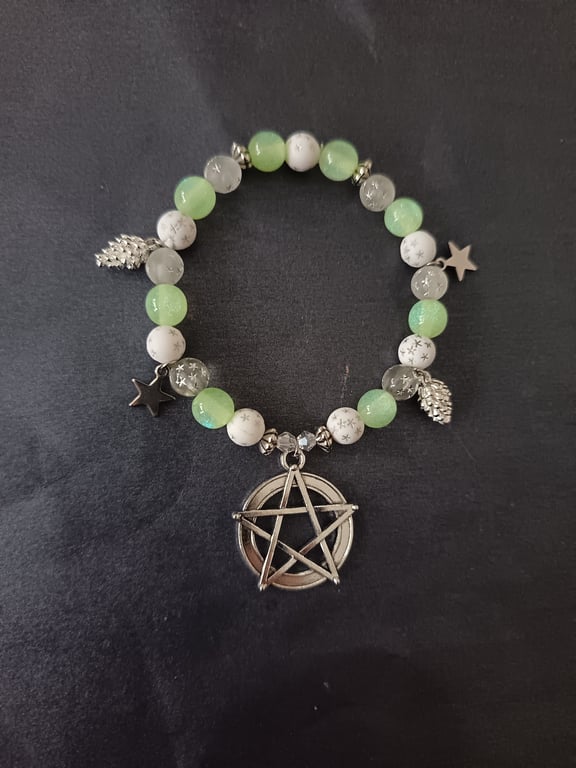 Elasticated beaded bracelet with silver pentacle, star and pine cone charms