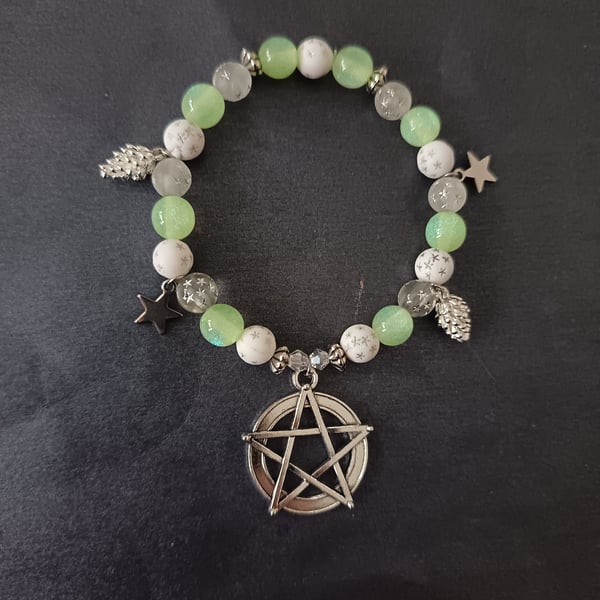 Elasticated beaded bracelet with silver pentacle, star and pine cone charms