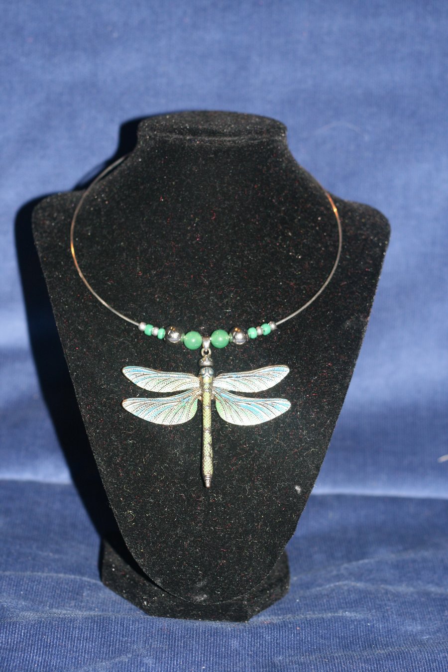 Large metal dragonfly necklace on silver plated neck wire