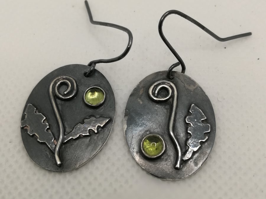 Antiqued Sterling Silver and Peridot unfurling fern earrings.