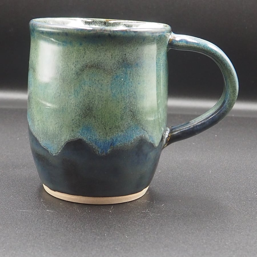 Large stoneware pottery mug finished in a multi-coloured green and blue glaze