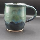 Large stoneware pottery mug finished in a multi-coloured green and blue glaze