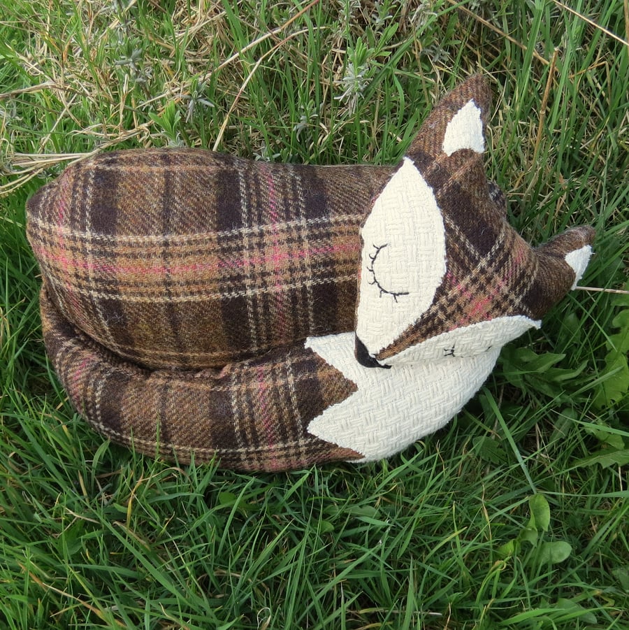 A large snoozy fox cushion in tartan wool. 39cm in length.