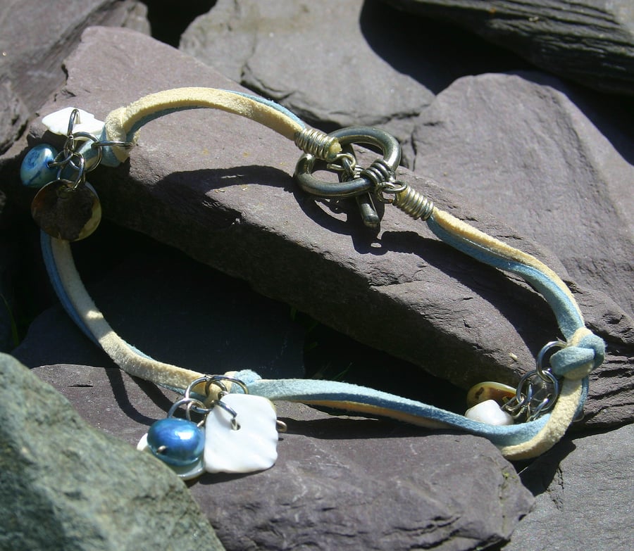 Light blue and cream suede anklet with toggle clasp and charms.