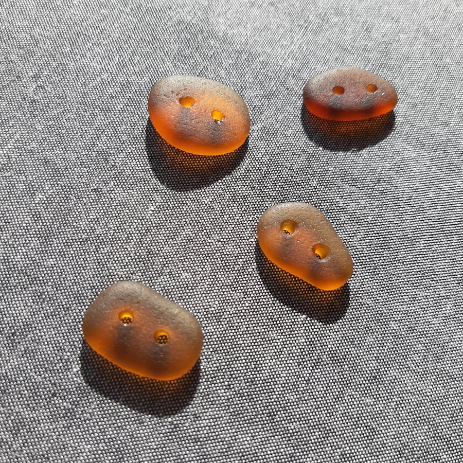 A set of four brown sea glass buttons