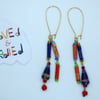 Dangling multicoloured earrings made of paper beads