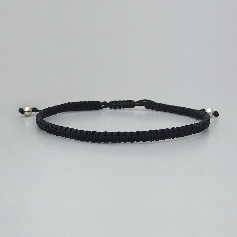 Black macramé bracelet with silver plated bead ends. Extends from 7” to 9.5