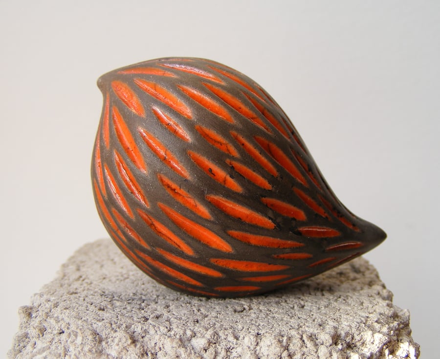 Orange, carved raku baby bird