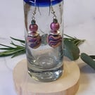 Handmade dangly polymer clay earrings in a colourful swirl design