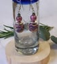Handmade dangly polymer clay earrings in a colourful swirl design