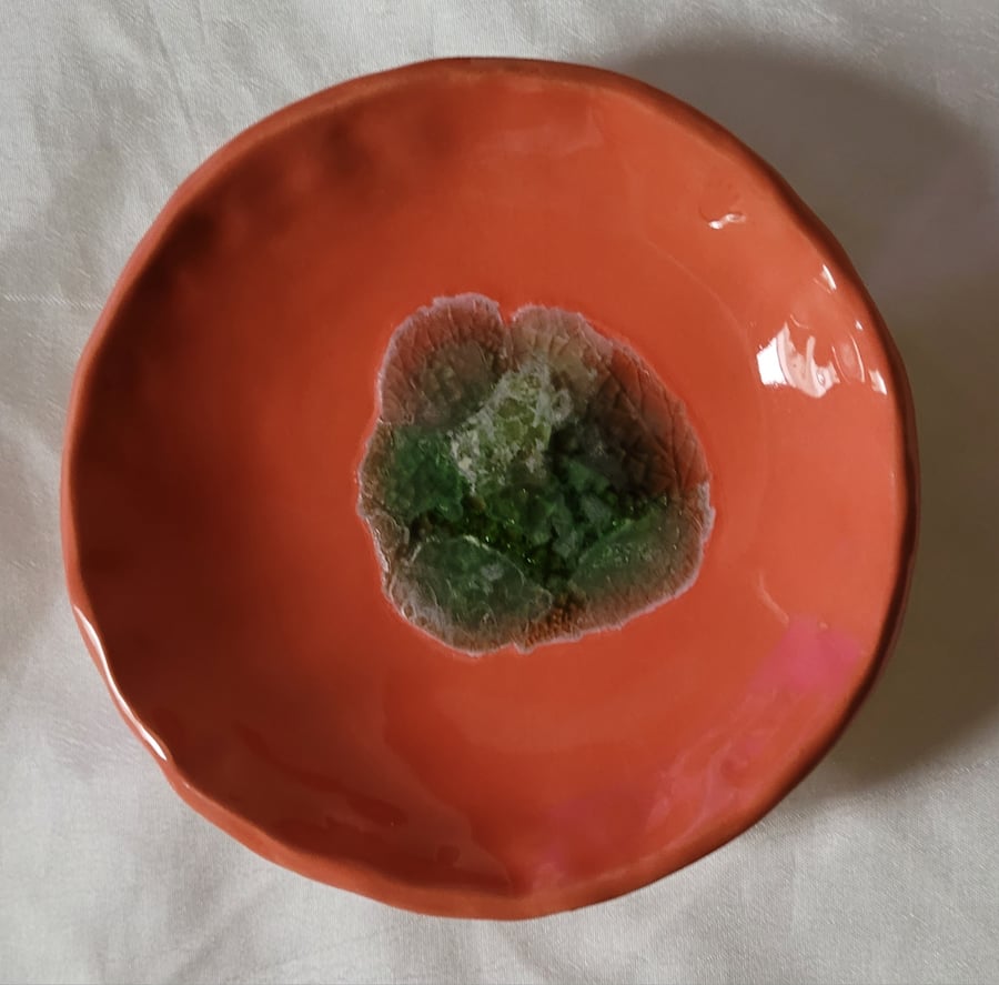 A ceramic ring dish with sea glass